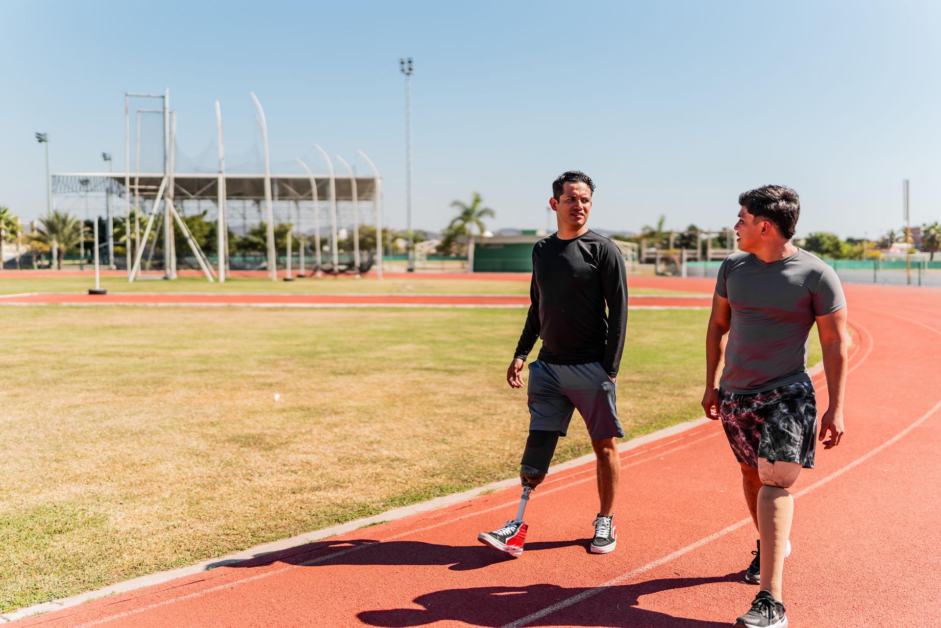 Athletes with artificial leg walking on sports track